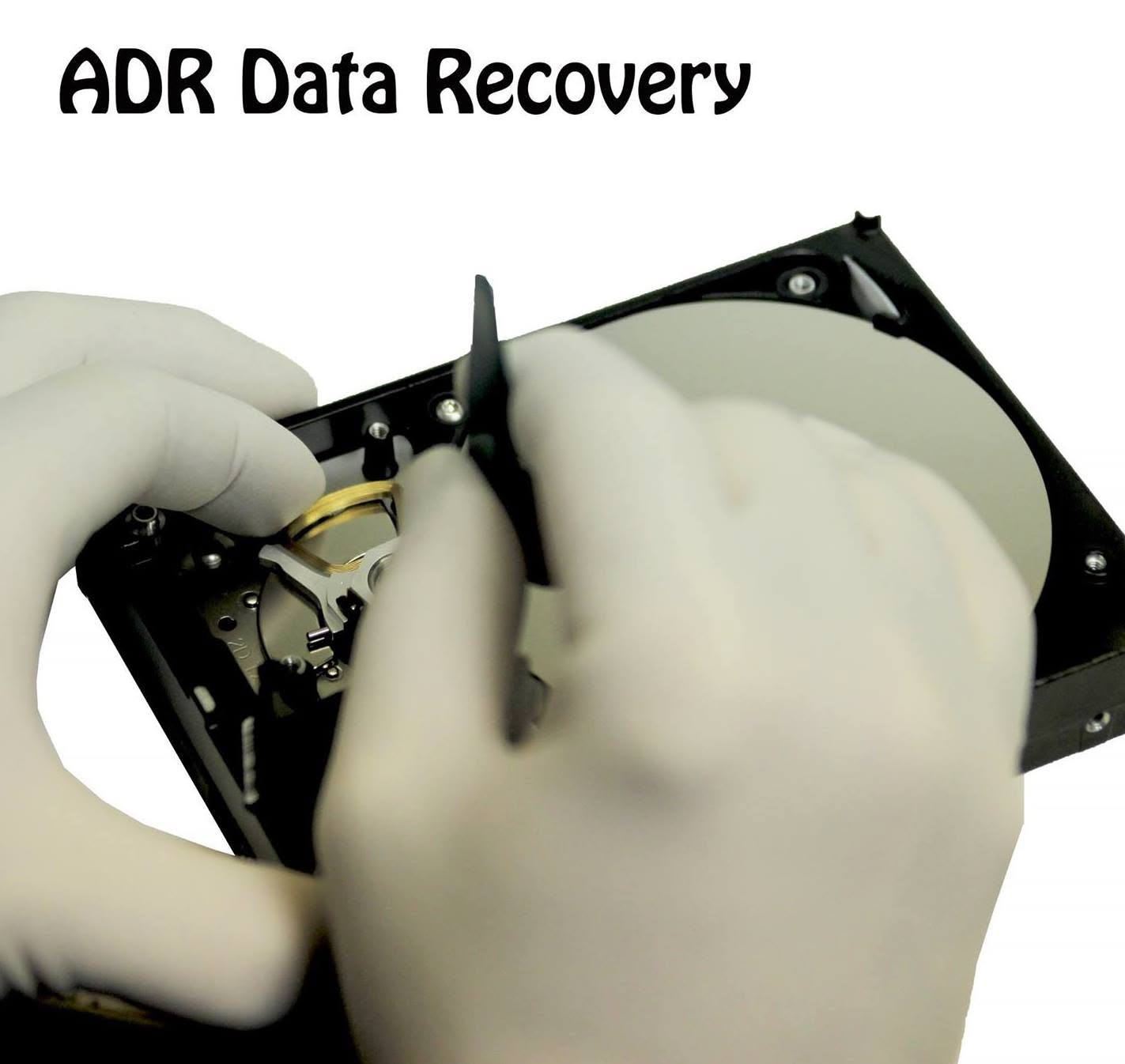 Gloved ADR technician performing precision work on an opened hard drive