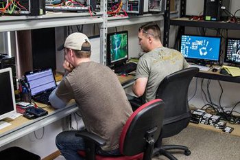 ADR technicians evaluating recovery work at a laboratory bench
